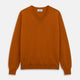 The Turnbull & Asser Rust Paden V-Neck Jumper, a pure cashmere sweater with long sleeves and ribbed cuffs and hem, is laid flat on a white background with the label visible at the neck.