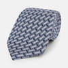 View 1 of product The Turnbull & Asser Navy and Pink Weave Patterned Silk Tie is shown elegantly rolled up on a white background.