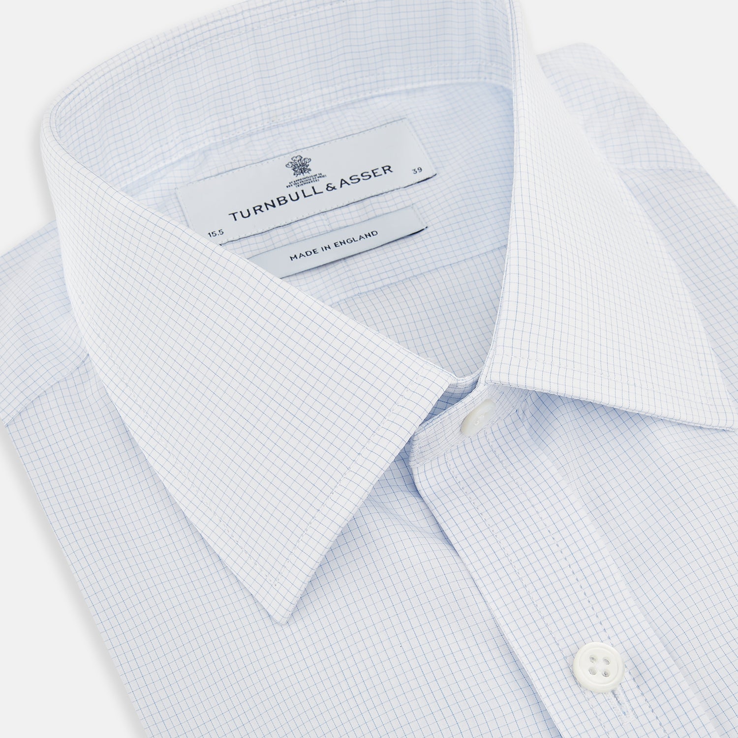 View 2 of product The Turnbull & Asser Blue and White Micro Check Mayfair Shirt features a pointed collar and white buttons, shown flat against a white background.