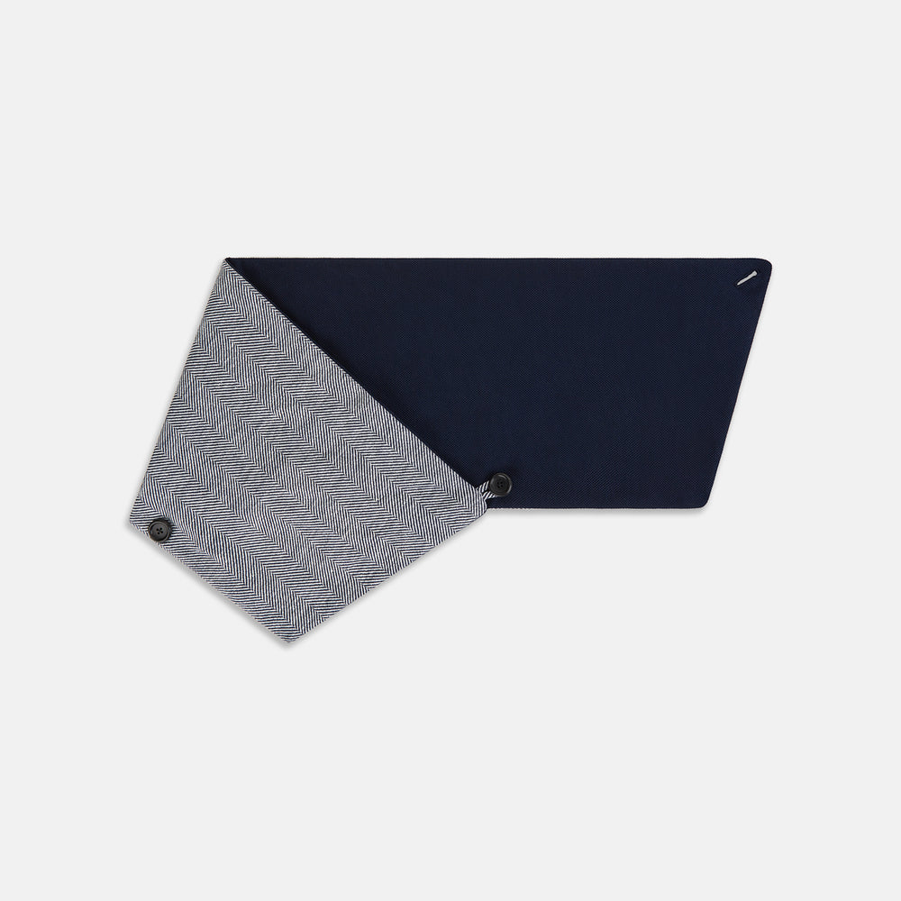 The Turnbull & Asser Navy Herringbone Silk and Linen Neck Warmer features a grey and white pattern, button closure, and dark navy lining—a refined formal accessory for any wardrobe.