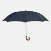 View 1 of product The Turnbull & Asser Navy Telescopic Umbrella features a brown maple crook handle and is shown fully open against a plain white background.