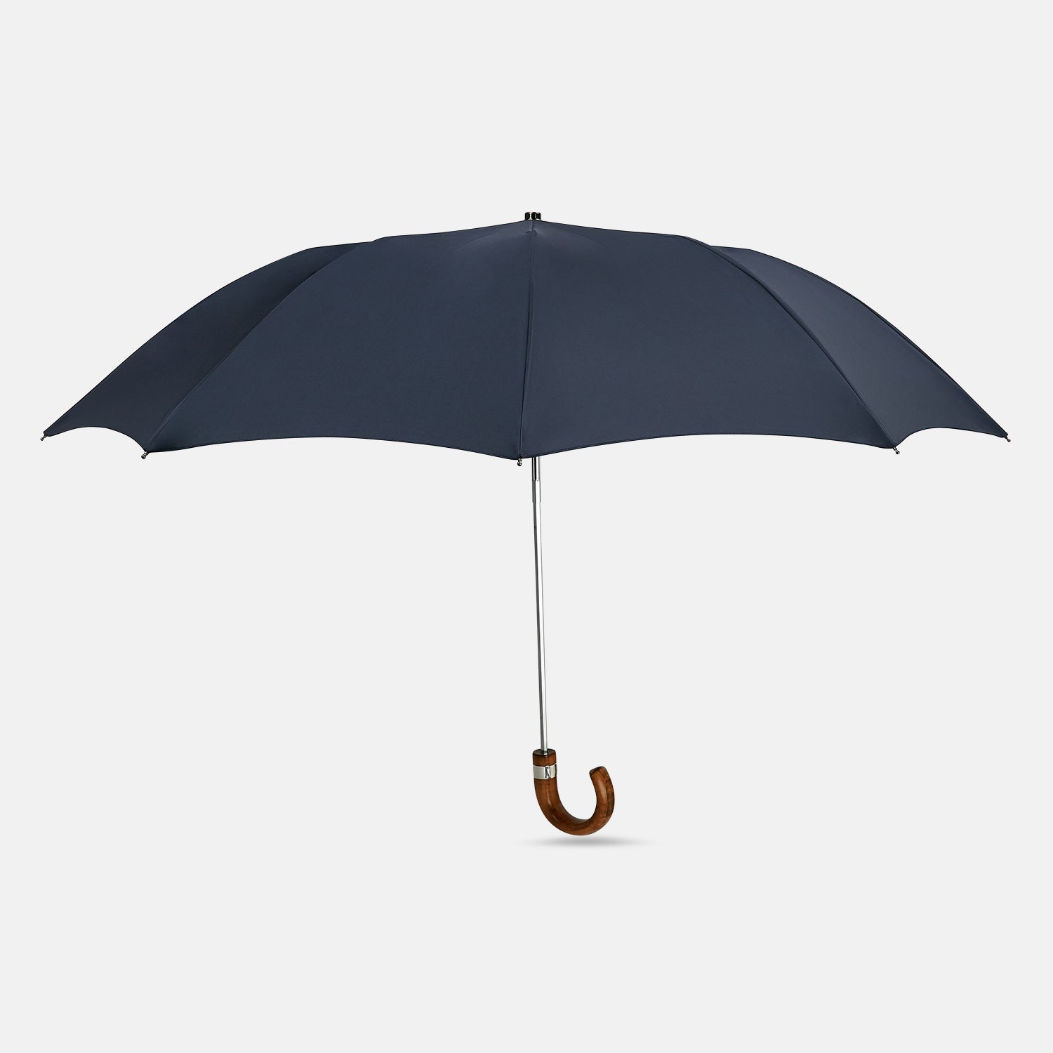 View 1 of product The Turnbull & Asser Navy Telescopic Umbrella features a brown maple crook handle and is shown fully open against a plain white background.