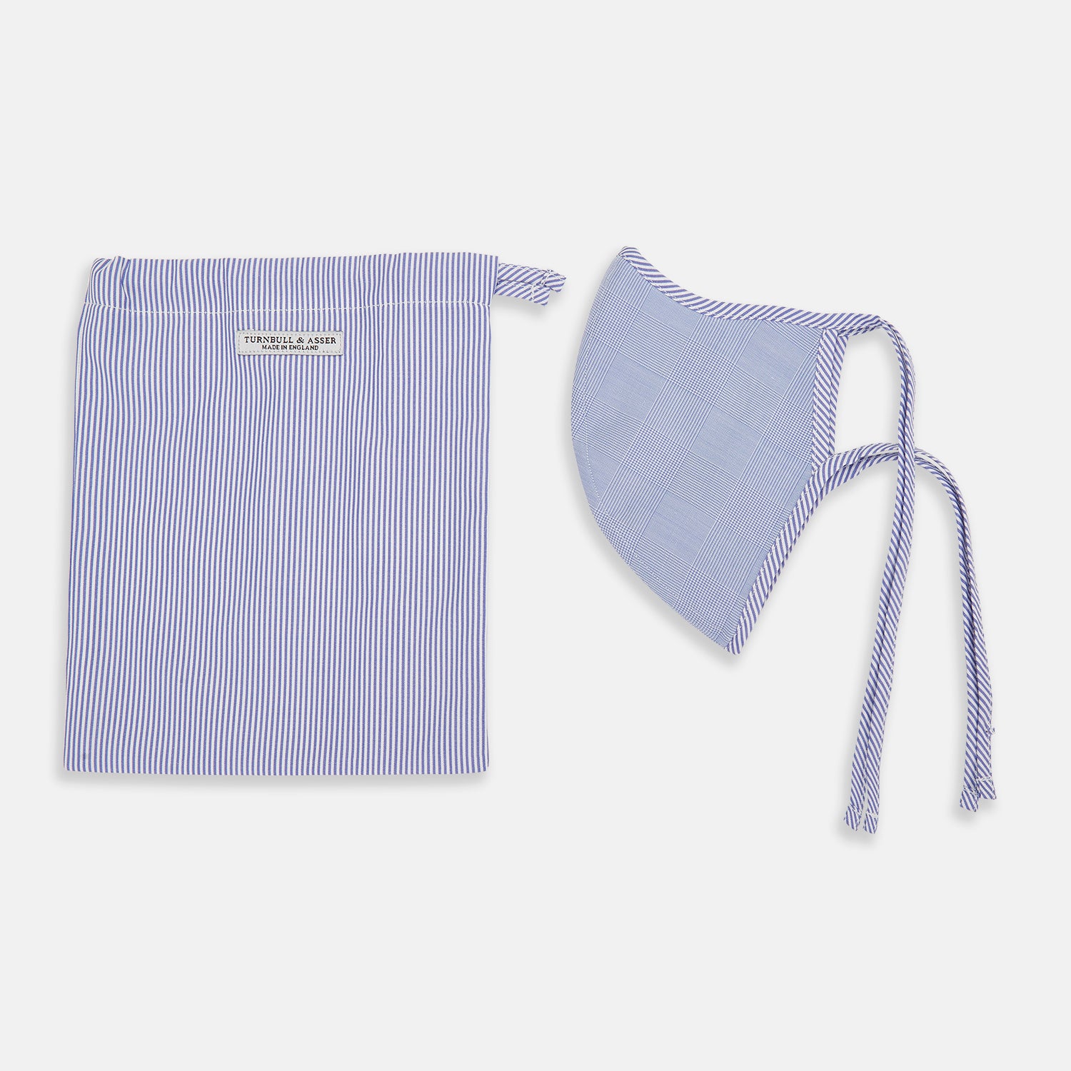 View 2 of product The Turnbull & Asser Blue Fine Check Zephyr Cotton Commuter Mask features a light blue and white check pattern, adjustable side ties, and comes with 3 Viroformula™ filters. Shown on a plain white background.