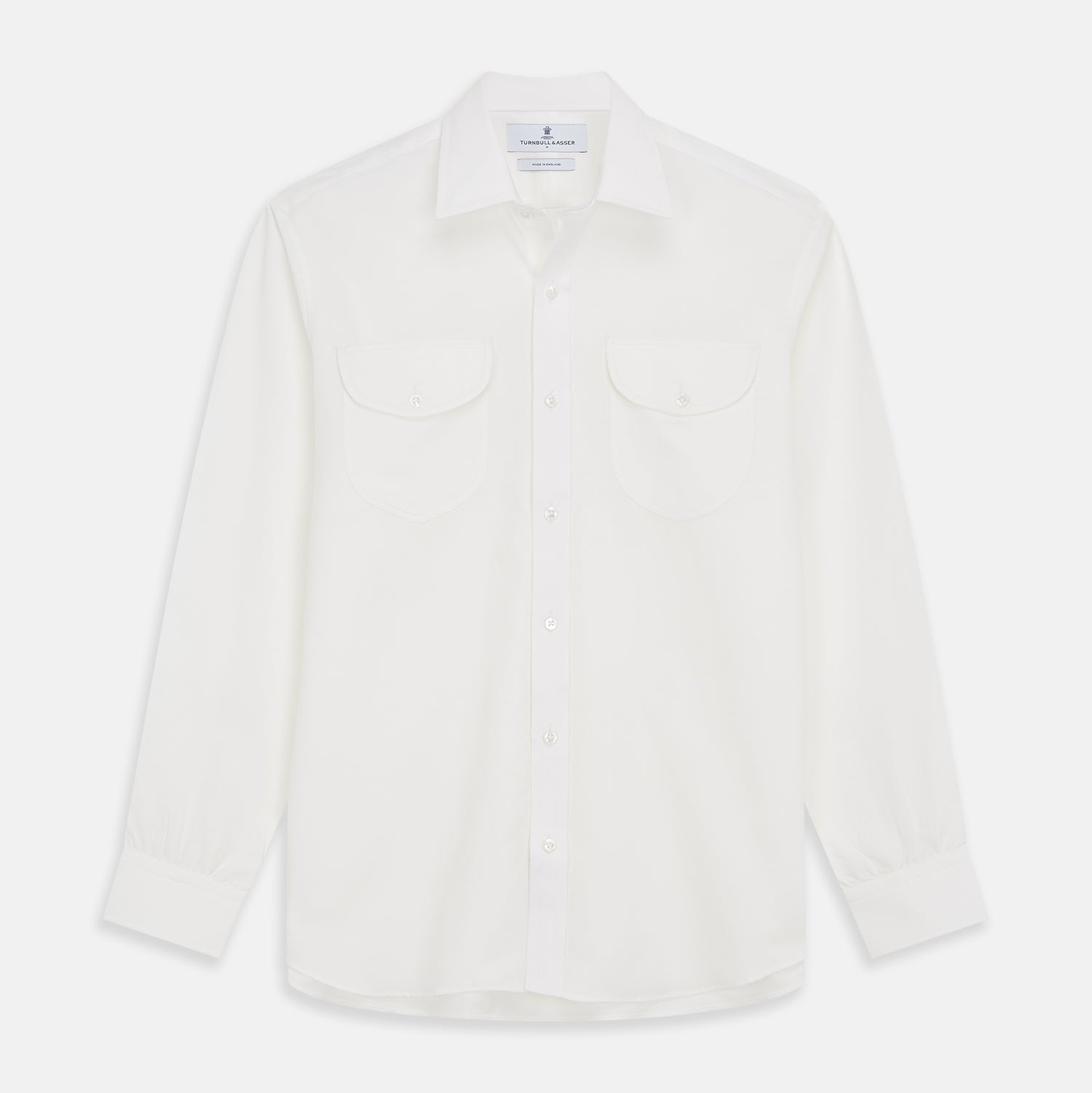 View 1 of product The White Cotton Weekend Fit Langston Shirt by Turnbull & Asser, with a Derby collar, long sleeves, and two button-flap chest pockets, is shown laid flat on a white background.