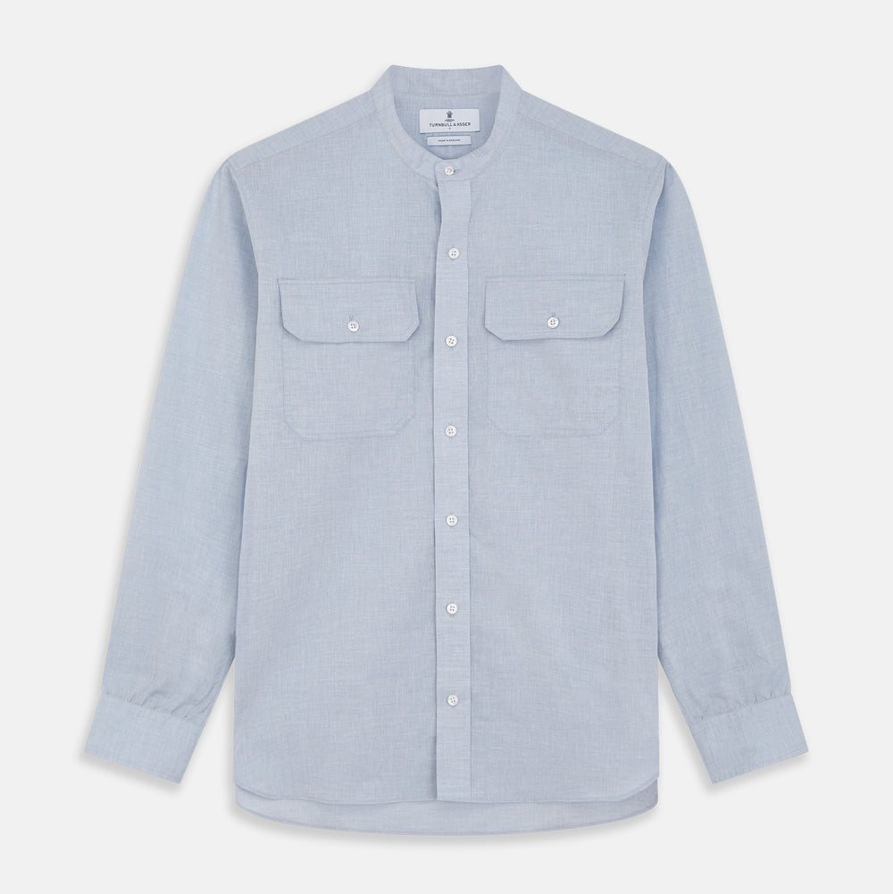Turnbull & Asser’s Pale Blue Linen Blend Weekend Fit Unwin Shirt features long sleeves, a band collar, two chest pockets, and white buttons—ideal for casual summer wear.
