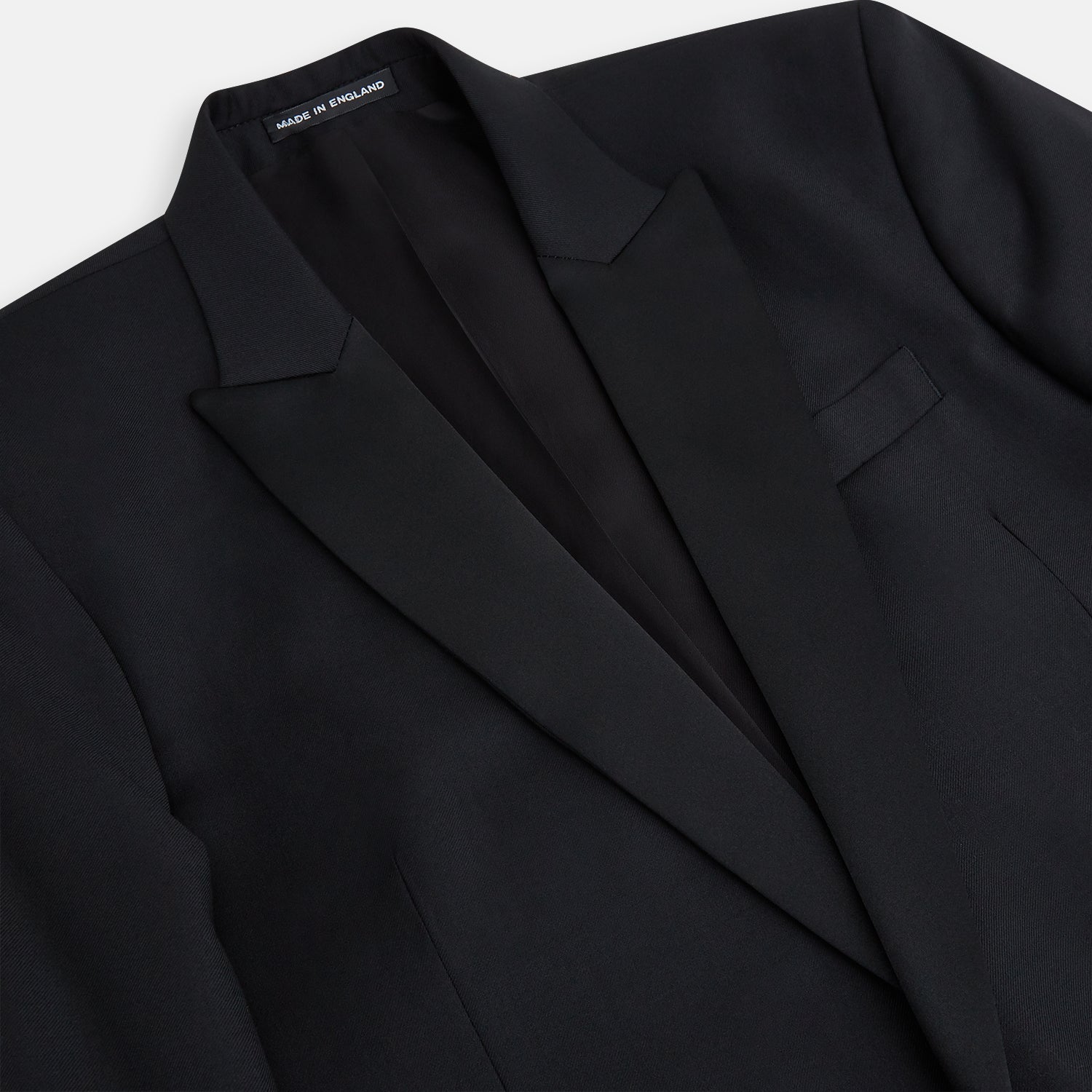 View 2 of product The Turnbull & Asser Black Single Breasted Dinner Suit features fine wool, a satin shawl collar jacket, and matching trousers—perfect formal wear, shown on a plain white background.