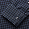 View 4 of product The Turnbull & Asser Navy Check Cotton Weekend Fit Blake Shirt features a long-sleeve, button-up design with a stand collar and white buttons, shown on a white background.