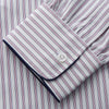 View 3 of product The Turnbull & Asser Red and Blue Multi Stripe Cotton Sussex Nightshirt features long sleeves, a knee-length cut, collared neckline, button placket, chest pocket with dark trim, and rounded hem for luxurious sleepwear.
