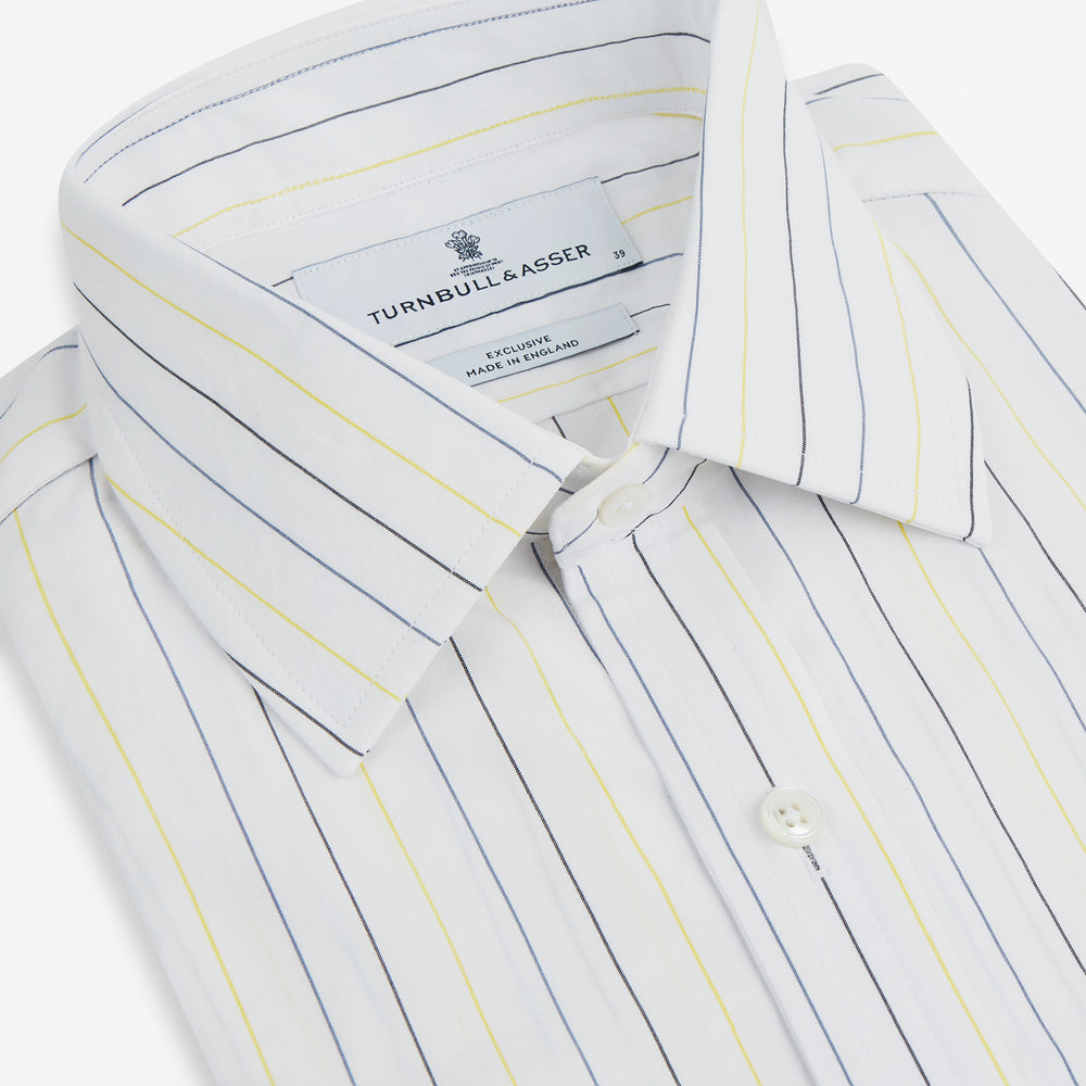 The Navy and Yellow Wide Pinstripe Mayfair Shirt by Turnbull & Asser is a long-sleeve, button-up shirt with wide navy and yellow pinstripes, a collar, and buttoned cuffs, laid flat on a white surface.