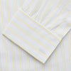 View 3 of product The Turnbull & Asser Yellow Multi Stripe Cotton Regular Fit Whitby Shirt features long sleeves, a classic collar, and thin yellow and blue stripes on white, displayed on a plain white surface.