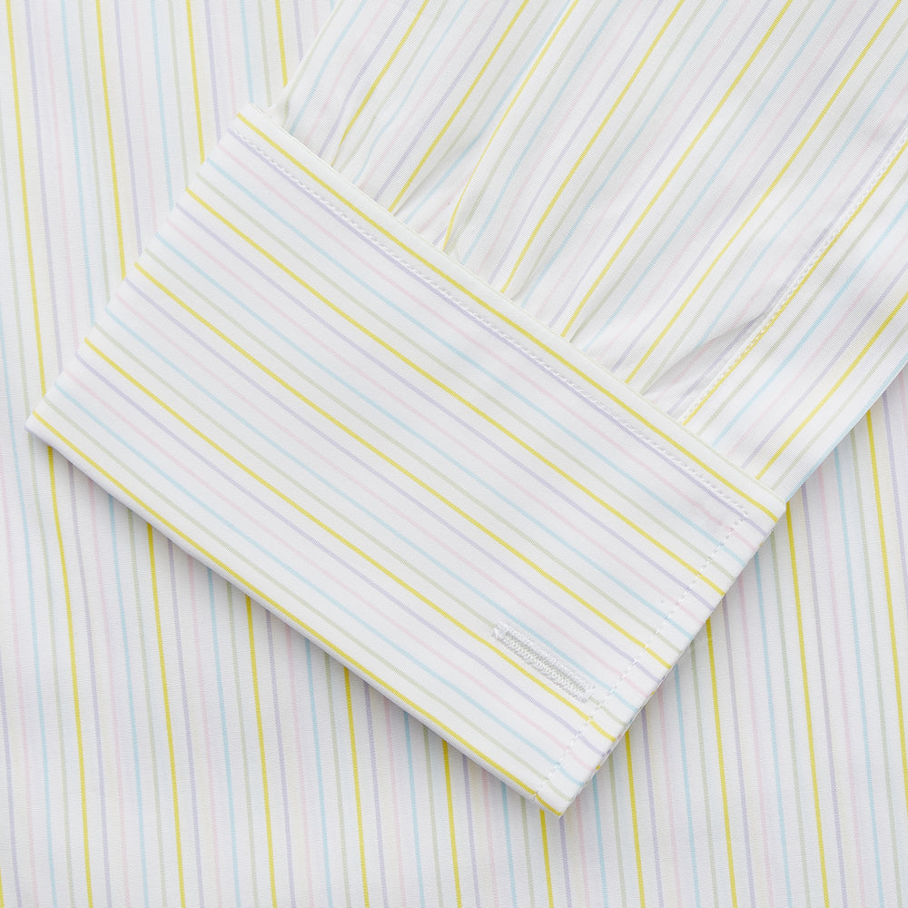 The Turnbull & Asser Yellow Multi Stripe Cotton Regular Fit Whitby Shirt features long sleeves, a classic collar, and thin yellow and blue stripes on white, displayed on a plain white surface.