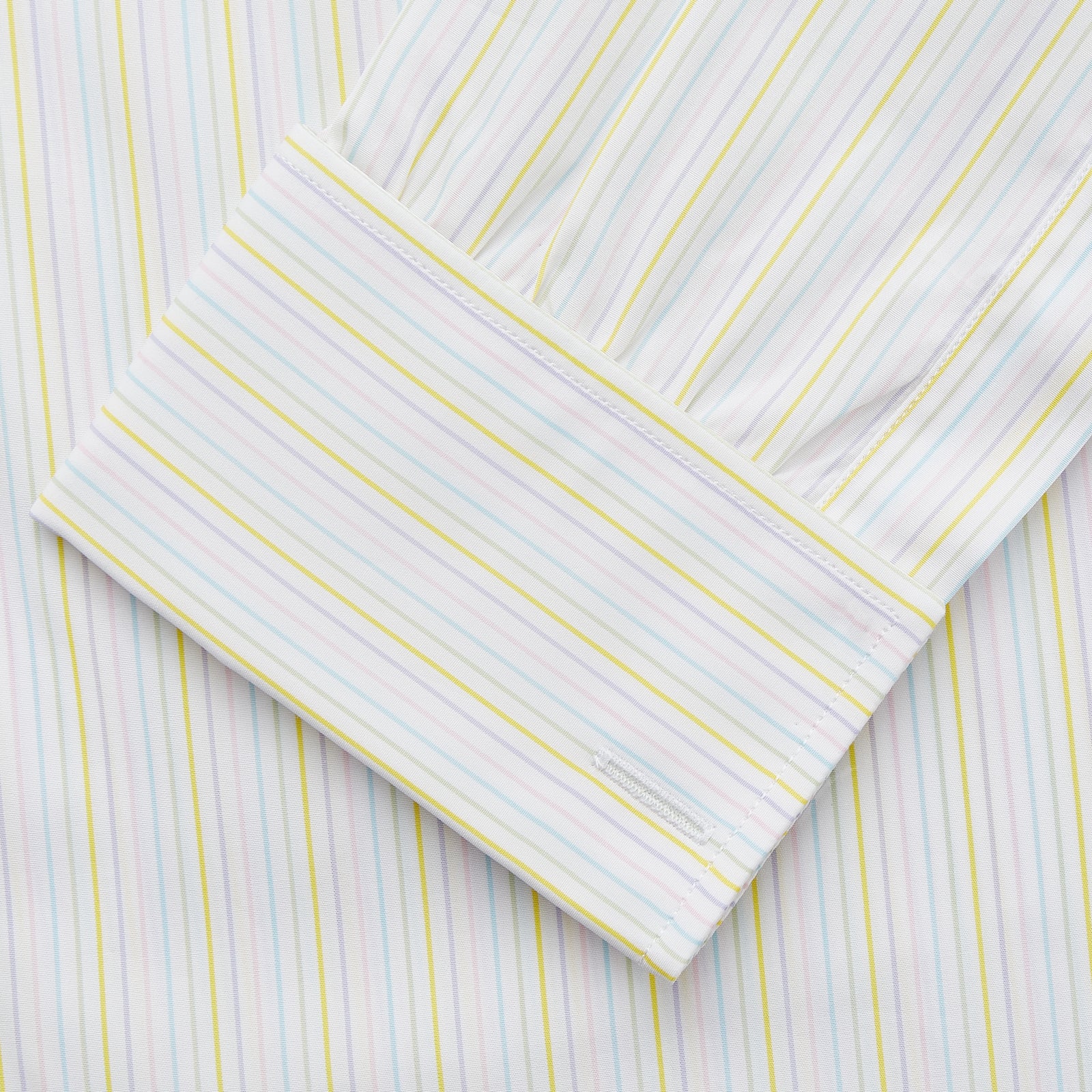 View 3 of product The Turnbull & Asser Yellow Multi Stripe Cotton Regular Fit Whitby Shirt features long sleeves, a classic collar, and thin yellow and blue stripes on white, displayed on a plain white surface.