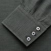 View 3 of product The Turnbull & Asser Dark Green Cotton Melange Regular Fit Mayfair Shirt features long sleeves, a T&A collar, buttoned cuffs, and a slightly rounded hem, shown laid flat on a white background.