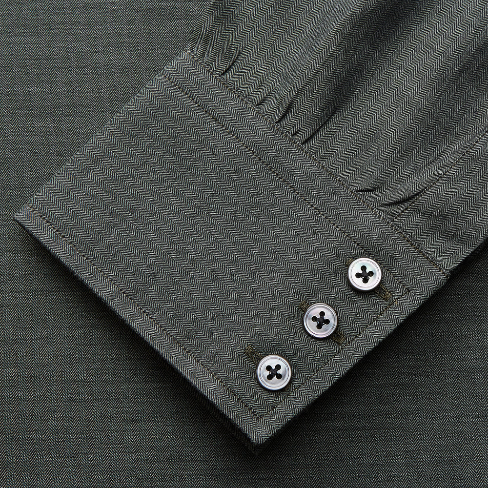 The Turnbull & Asser Dark Green Cotton Melange Regular Fit Mayfair Shirt features long sleeves, a T&A collar, buttoned cuffs, and a slightly rounded hem, shown laid flat on a white background.