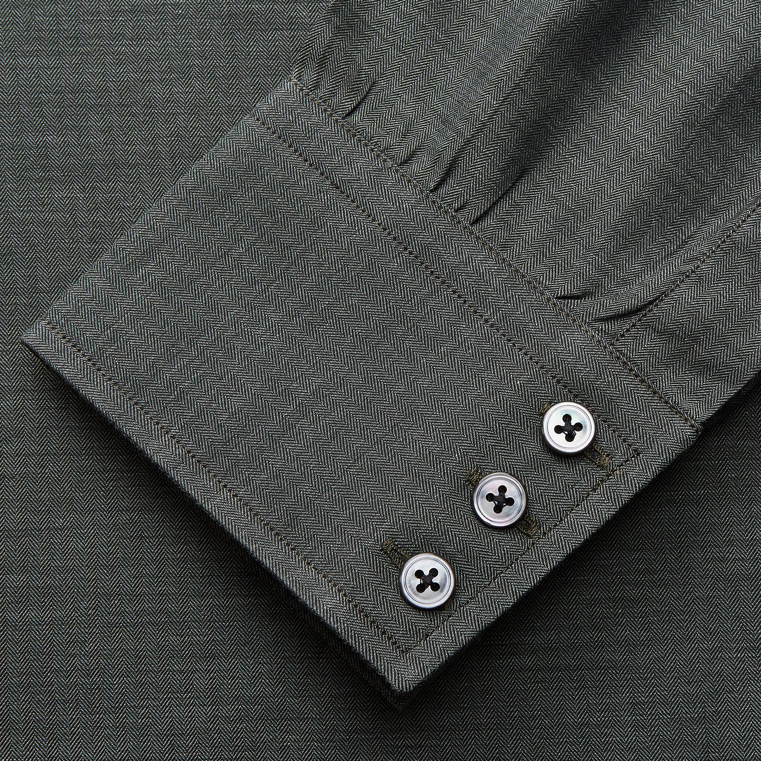 View 3 of product The Turnbull & Asser Dark Green Cotton Melange Regular Fit Mayfair Shirt features long sleeves, a T&A collar, buttoned cuffs, and a slightly rounded hem, shown laid flat on a white background.
