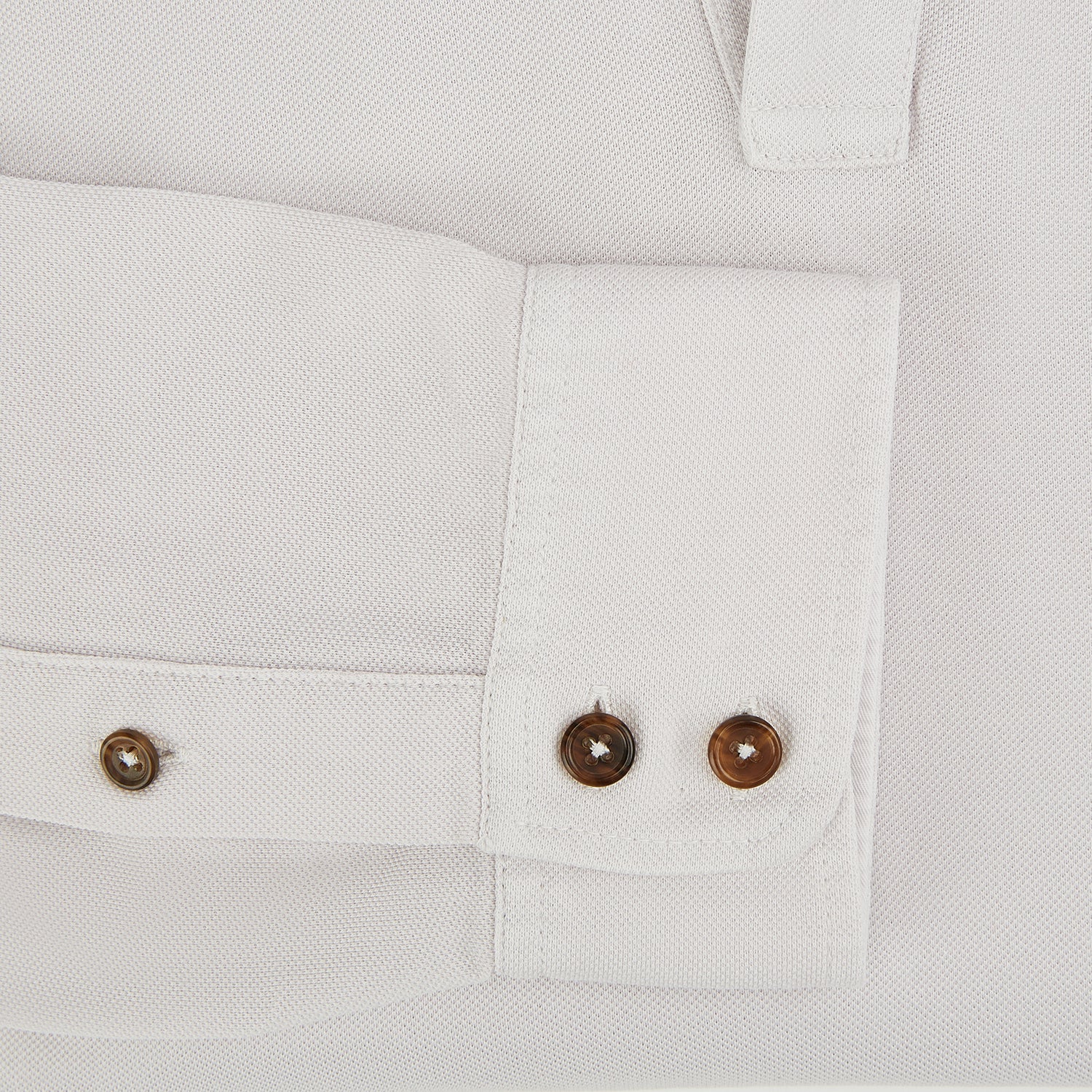 View 4 of product A pale pink luxury cotton rugby polo shirt by Turnbull & Asser, featuring long sleeves and a collar with no buttons, displayed flat on a white background.