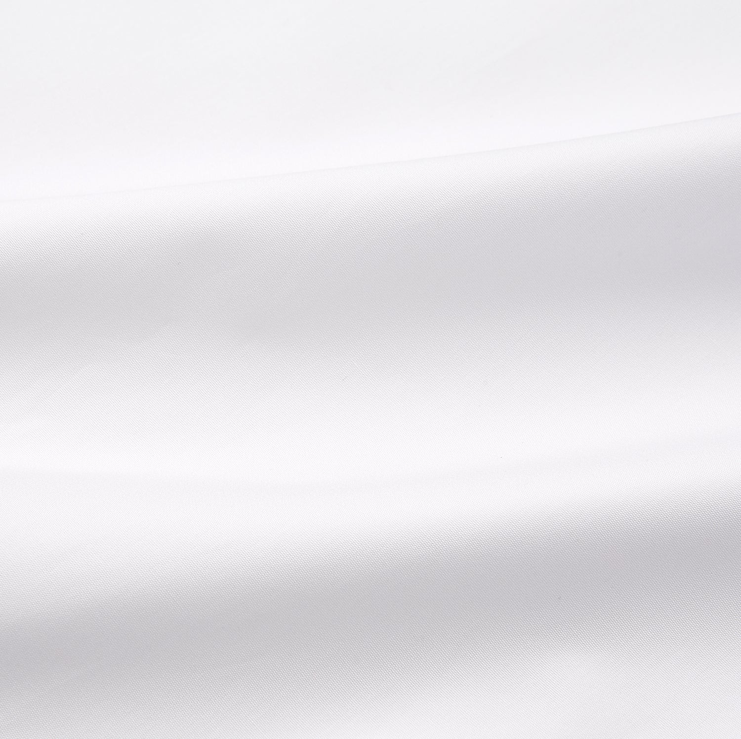 View 10 of product A woman with straight brown hair pulled back wears the Turnbull & Asser White Cotton Marlene Shirt, featuring classic menswear details, paired with high-waisted cream trousers against a neutral background.