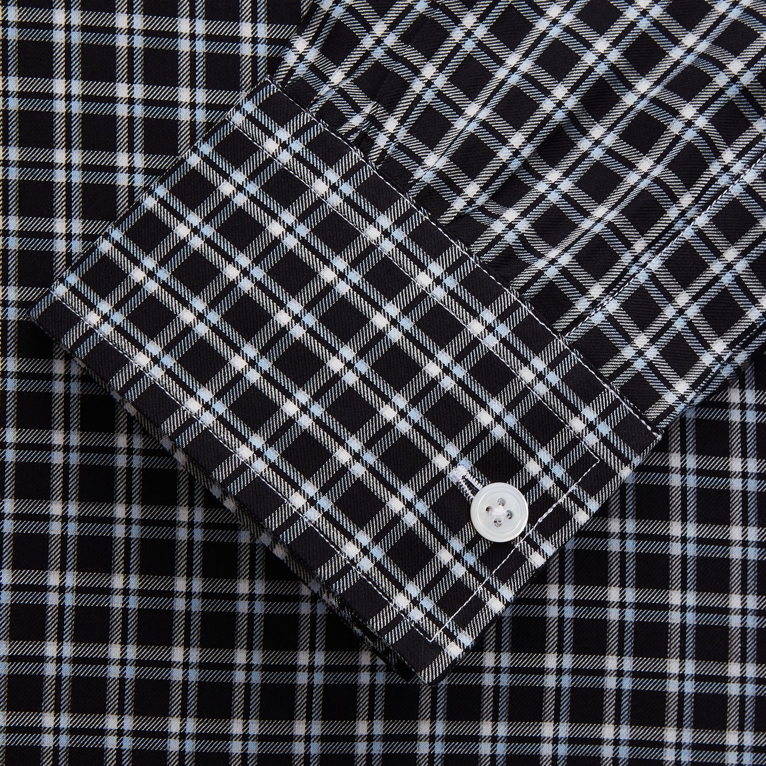 View 2 of product The Turnbull & Asser Black Multi Check Cotton Blend Weekend Fit Hayne Shirt features a Dorset button-down collar and white buttons, with a black and white plaid pattern, shown laid flat on a white background.