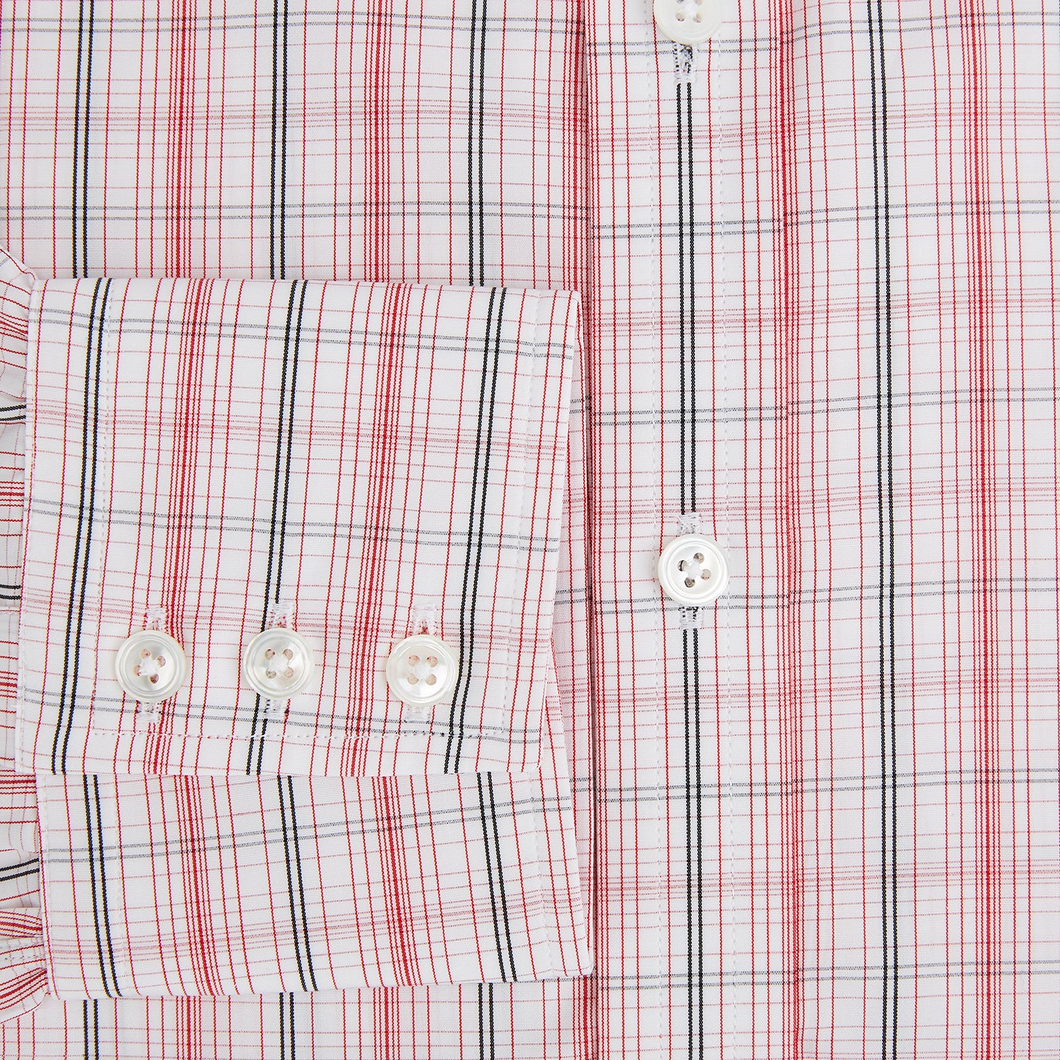 View 4 of product The Turnbull & Asser Red Multi Check Mayfair Shirt is a long-sleeve, button-up with a collar, crafted from Italian cotton and featuring a red multi check plaid pattern on white, shown laid flat against a white surface.
