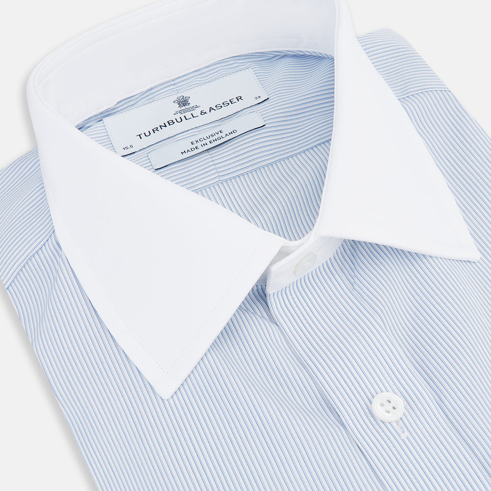 Turnbull & Asser Sky Blue Hairline Multi Stripe Shirt features a contrasting T&A collar and cuffs, long sleeves, and button-down front. Displayed against a plain white background.