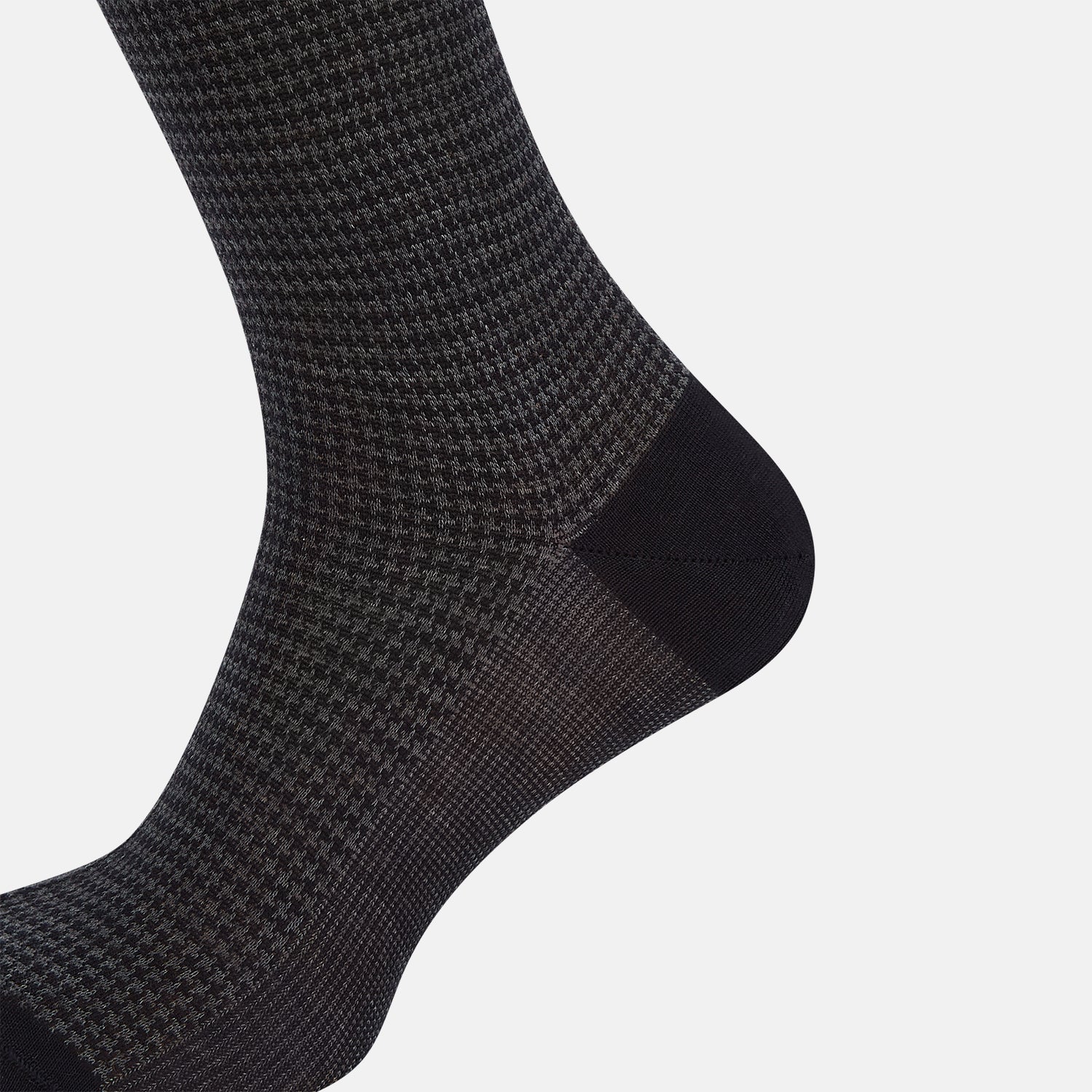 View 4 of product The Turnbull & Asser Charcoal Melange Houndstooth Mid-Length Sock features a black toe, heel, and cuff, and is shown singly against a plain white background.