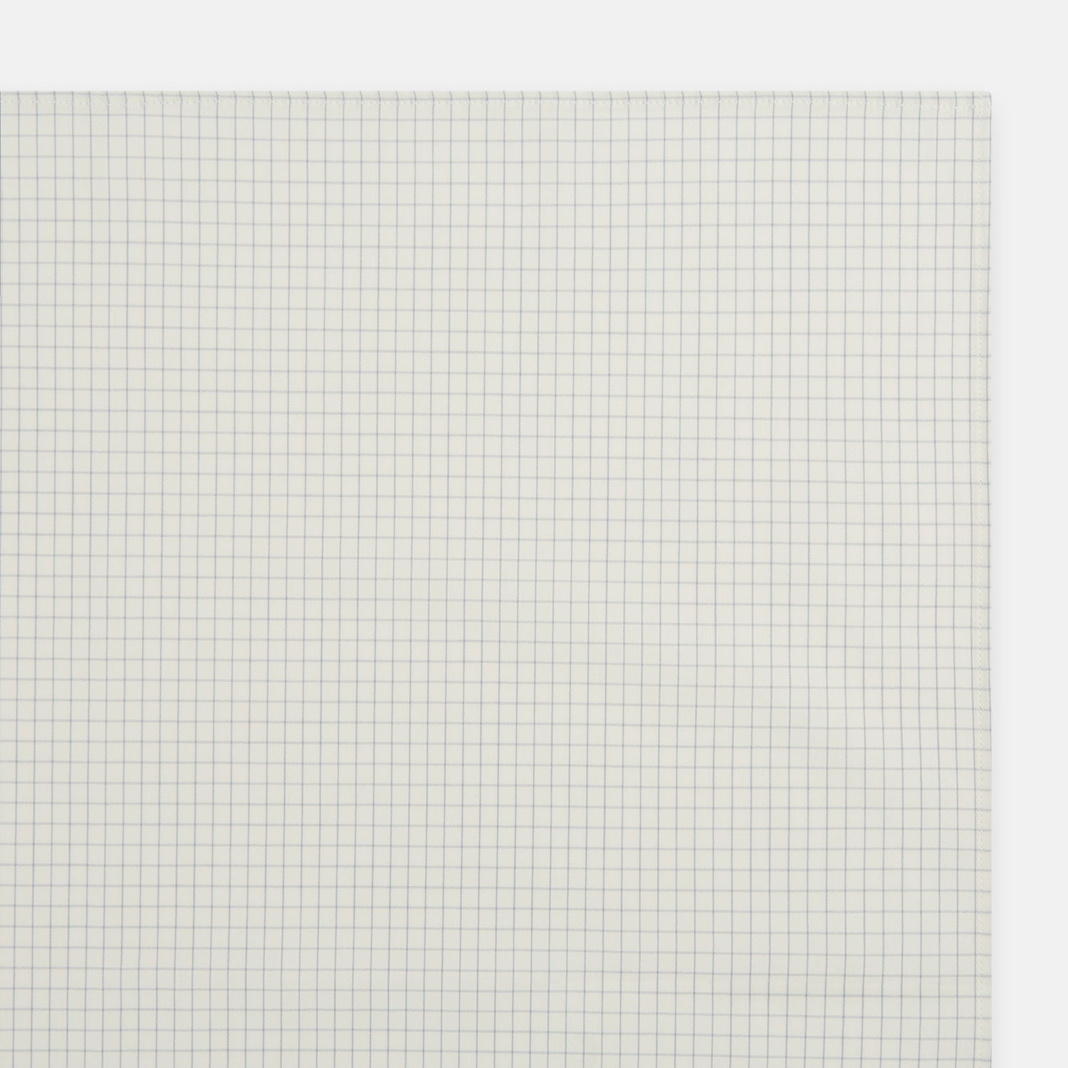 View 2 of product The Turnbull & Asser Pale Blue Graph Check Handkerchief features a refined white background with evenly spaced pale blue grid lines, evoking the minimalist elegance of classic graph paper in a luxurious accessory.