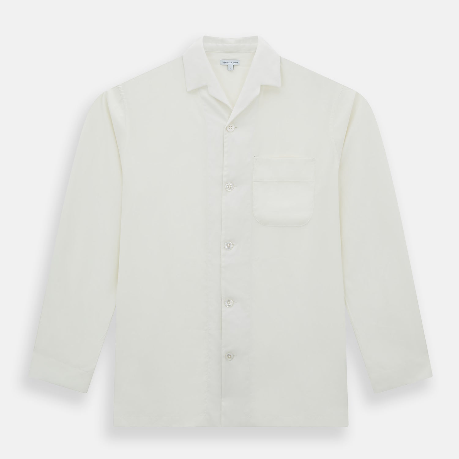 View 4 of product The Turnbull & Asser Cream Silk Pyjama Set, shown laid flat on a white background, features a long-sleeve button-up top with a chest pocket and matching pants with an elastic drawstring waist—ideal for comfortable loungewear.