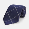 View 1 of product The Turnbull & Asser WINDOW PANE NAVY WHITE TIE features navy blue silk with a subtle diagonal ribbed texture and white windowpane checks, making it the perfect men’s accessory for any formal occasion.