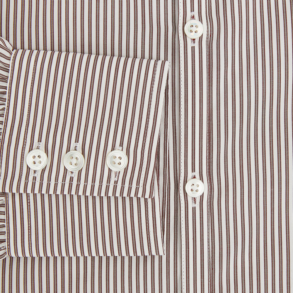 The Burgundy Halo Stripe Westminster Shirt by Turnbull & Asser features long sleeves, a button-up front, a Westminster collar, and thin vertical brown and white stripes, shown on a plain white background.
