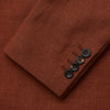 View 6 of product The Turnbull & Asser Rust Linen-Wool-Silk Bertie Blazer is a red double-breasted jacket with peak lapels, black buttons, and flap pockets, tailored in Italy from a luxury linen-wool-silk blend and shown on a white background.