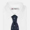 View 2 of product The Turnbull & Asser Jacquard Silk Circle Tie showcases a textured navy blue design with small white and light blue floral motifs—an essential accessory for refined attire.