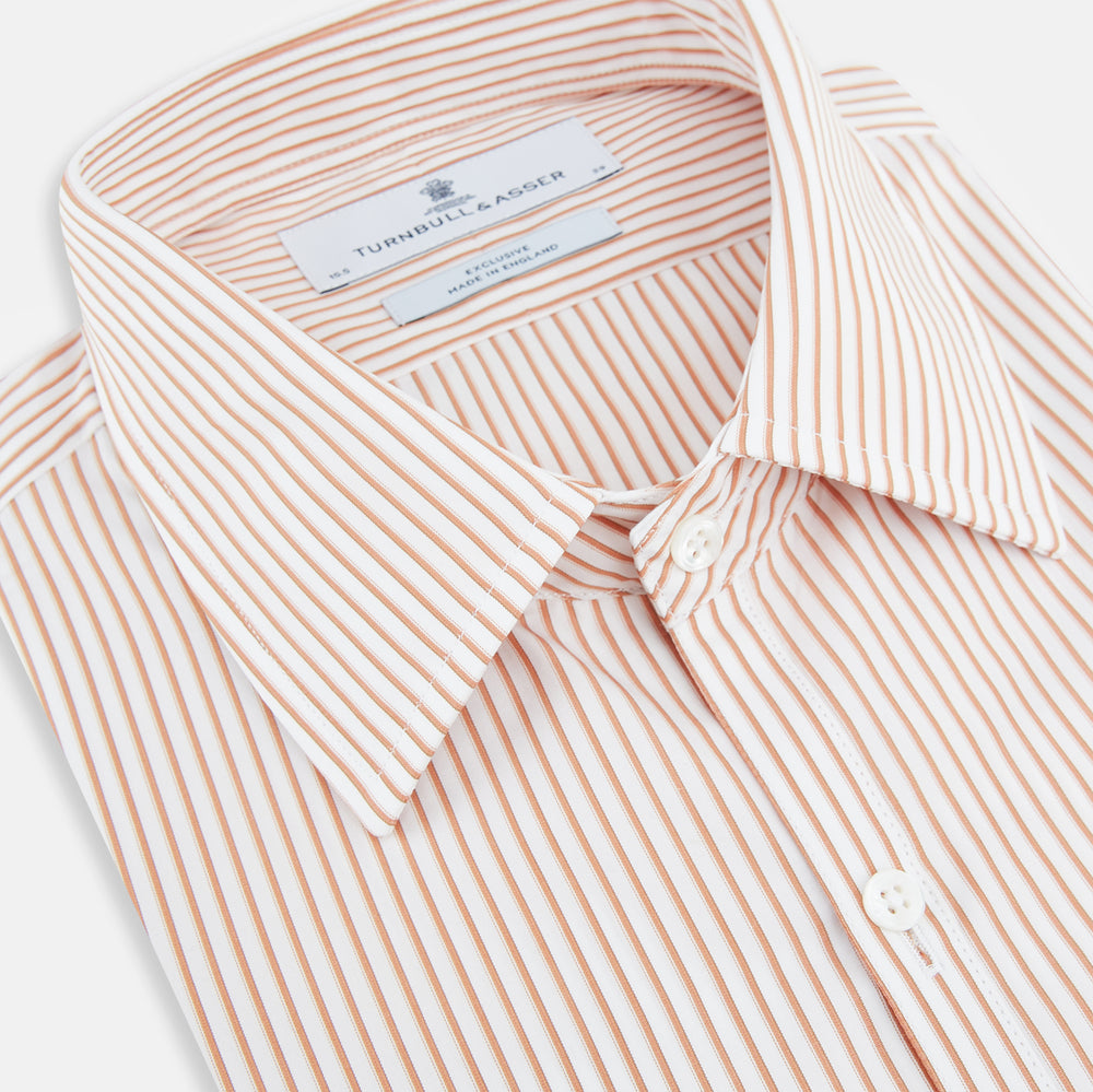 The Orange Multi Stripe Westminster Shirt by Turnbull & Asser features thin vertical orange and white stripes, a Turnbull collar, and long sleeves, elegantly displayed flat against a white background.