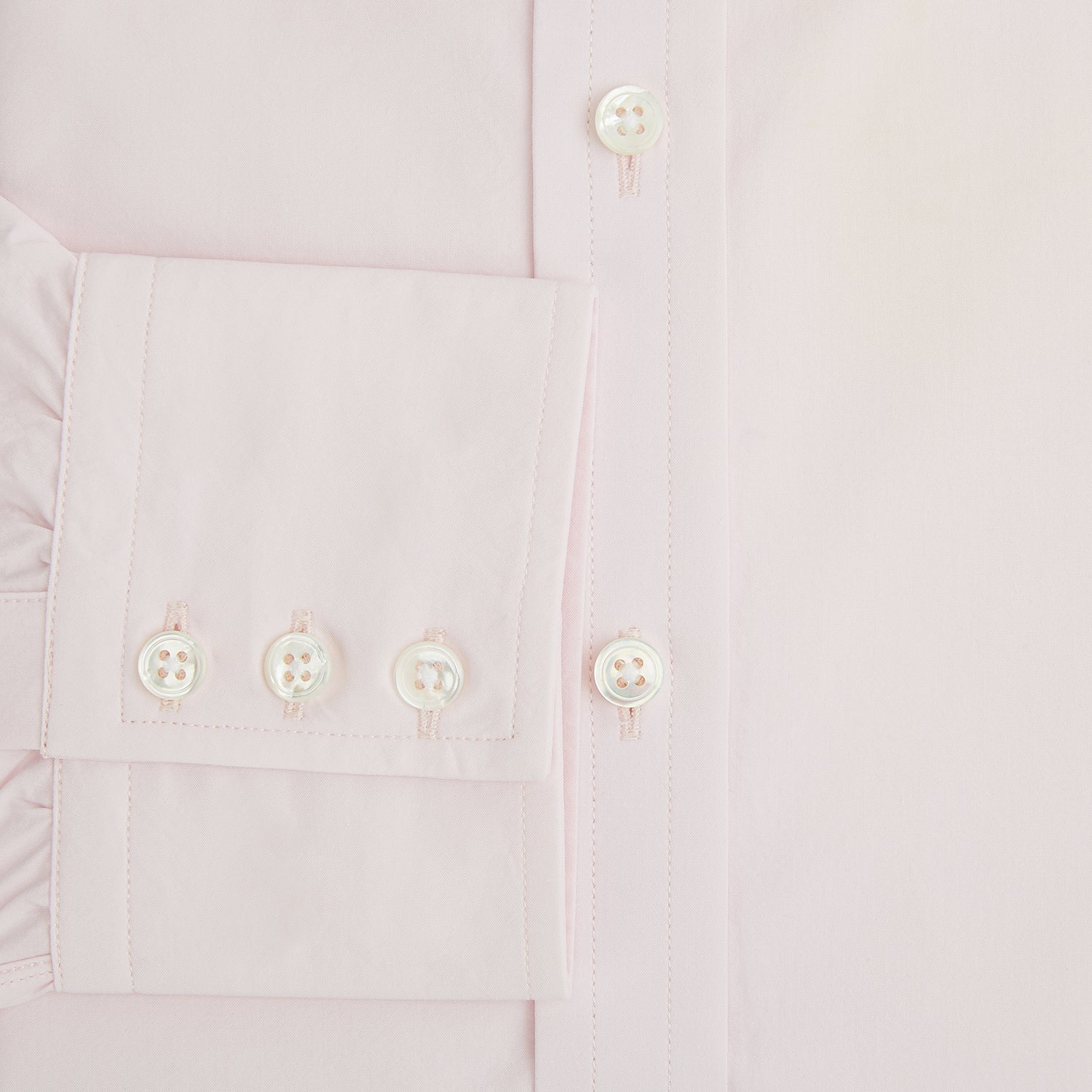 View 4 of product The Soft Pink Mayfair Shirt by Turnbull & Asser is a long-sleeved, sanforised cotton button-up with a classic collar, white buttons, and buttoned cuffs, shown against a plain white background.
