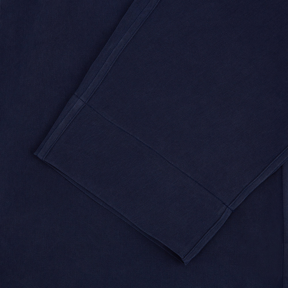 Turnbull & Asser Navy Silk Pyjama Set, laid flat on a white background, includes a long-sleeve button-up shirt with chest pocket and drawstring pants.