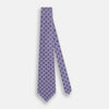 View 2 of product The Turnbull & Asser Lilac Medallion Silk Tie features a repeating navy medallion motif on textured lilac silk, adding refined style to any ensemble.
