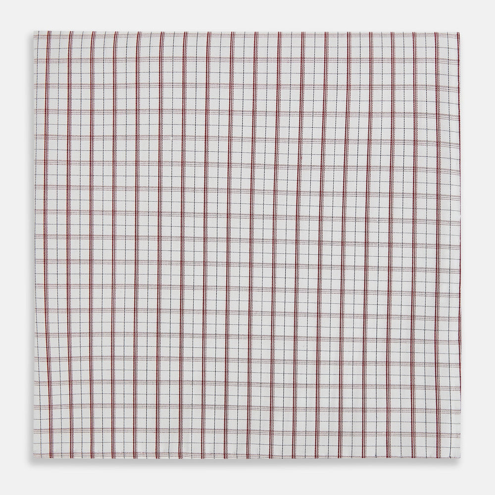 The Turnbull & Asser Red Tattersall Check Hand-Rolled Handkerchief features thin red and blue grid lines on white, laid flat in a rectangular shape and expertly crafted in England.