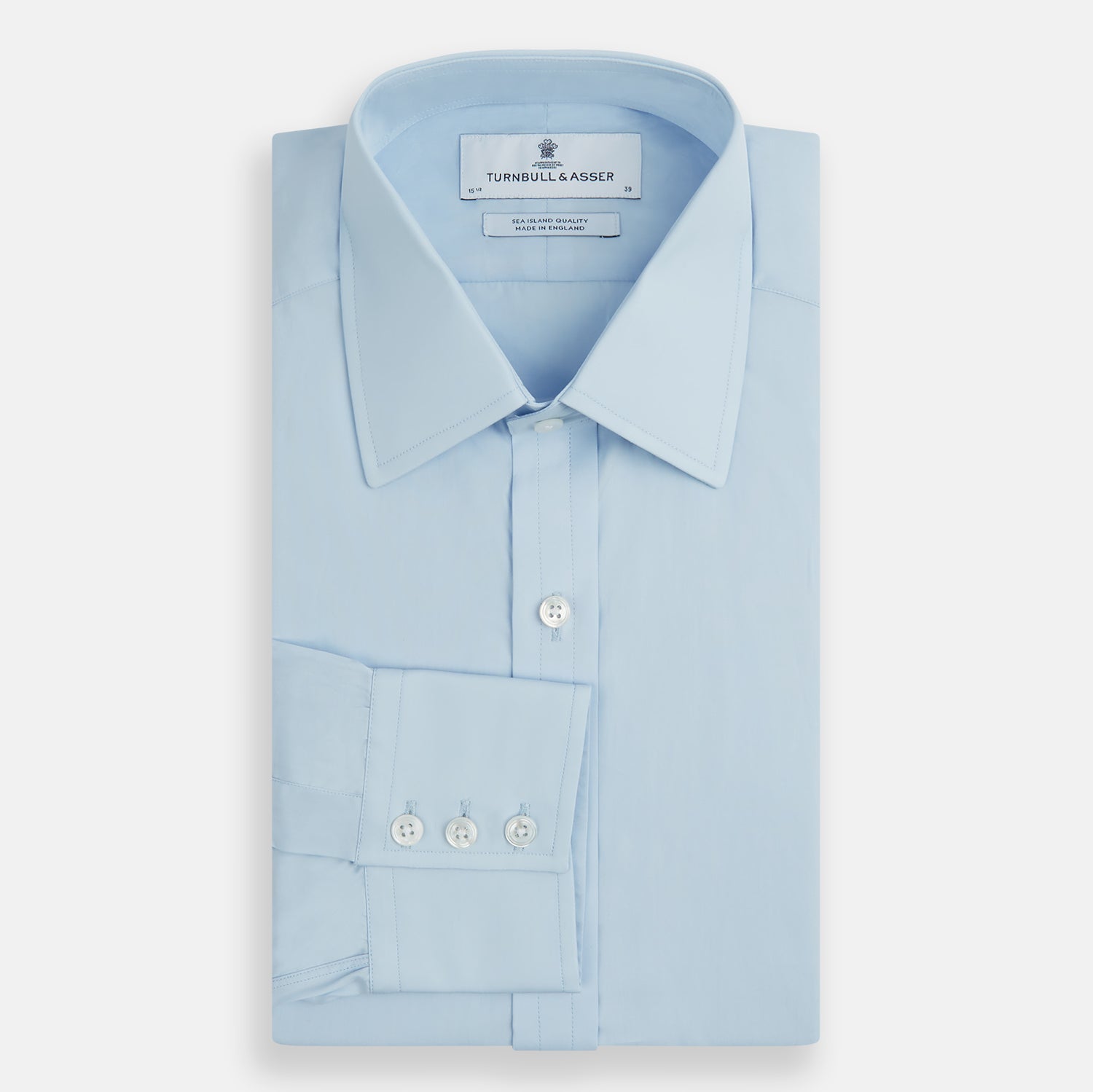 View 5 of product The Turnbull & Asser Light Blue Sea Island Quality Cotton Shirt features a T&A collar, 3-button cuffs, and premium cotton fabric, shown laid flat against a white background.