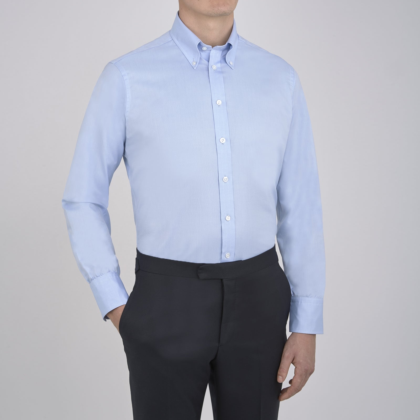 View 4 of product The Turnbull & Asser Light Blue Royal Oxford Cotton Shirt features a button-down collar, 3-button cuffs, and white buttons. Neatly folded with a visible inner label, it’s ideal to pair with a navy suit and displayed on a plain white background.