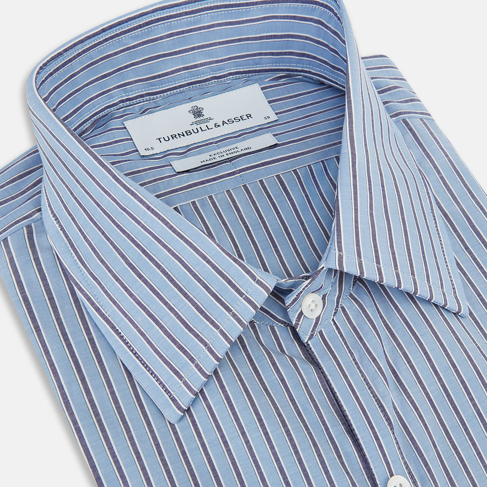 The Steel Blue Ticking Stripe Westminster Shirt by Turnbull & Asser features a classic fit, Turnbull collar, vertical stripes, white buttons, and buttoned cuffs—showcasing refined British craftsmanship.