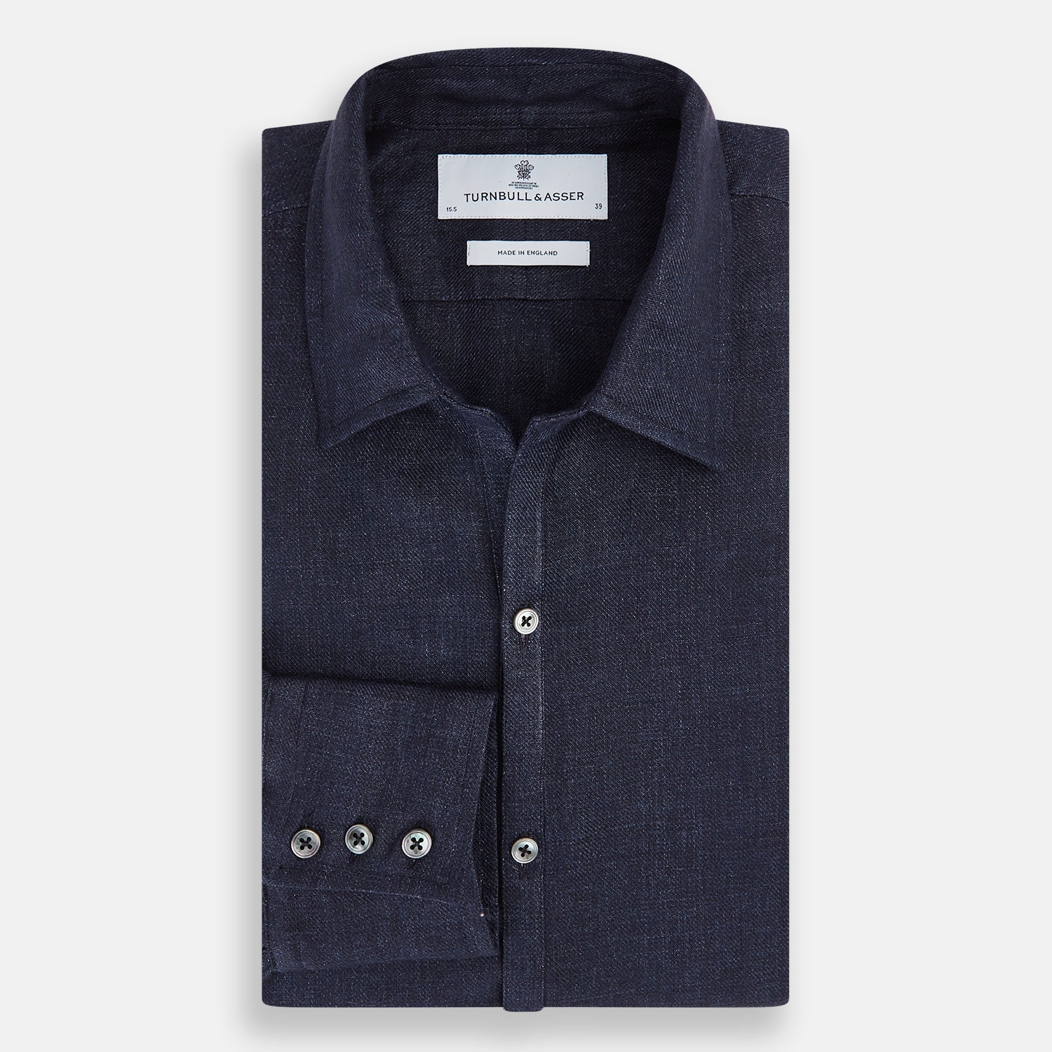 View 5 of product The Navy Linen Windsor Shirt by Turnbull & Asser features long sleeves, white buttons, a Turnbull collar, and buttoned cuffs in dark navy blue linen. Shown laid flat on a white background.