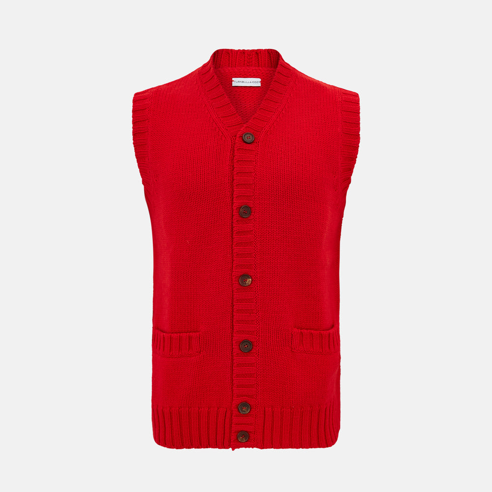 The Turnbull & Asser Red Merino V-Neck Sleeveless Cardigan features a ribbed collar, button front, and two front pockets—a refined lightweight layer—shown against a plain white background.