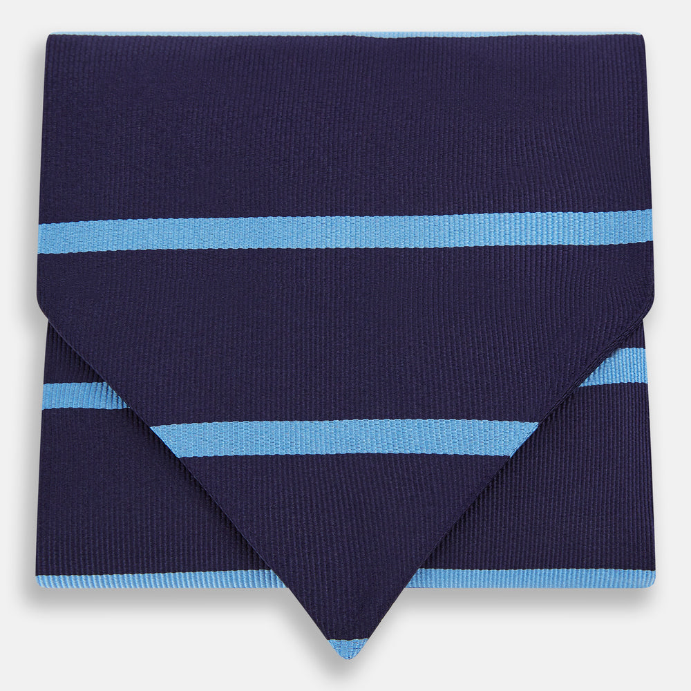 The Turnbull & Asser Azzurro Stripe and Navy Silk Cravat is elegantly displayed against a white background, featuring two horizontal light blue stripes and a bottom edge forming a downward-pointing triangle.