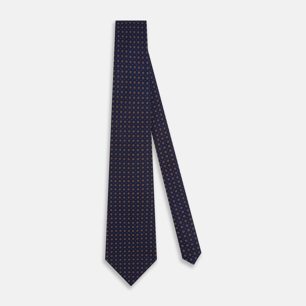The Turnbull & Asser Navy and Brown Circle Silk Tie features an elegant pattern, perfect for adding a refined touch to your modern office attire.