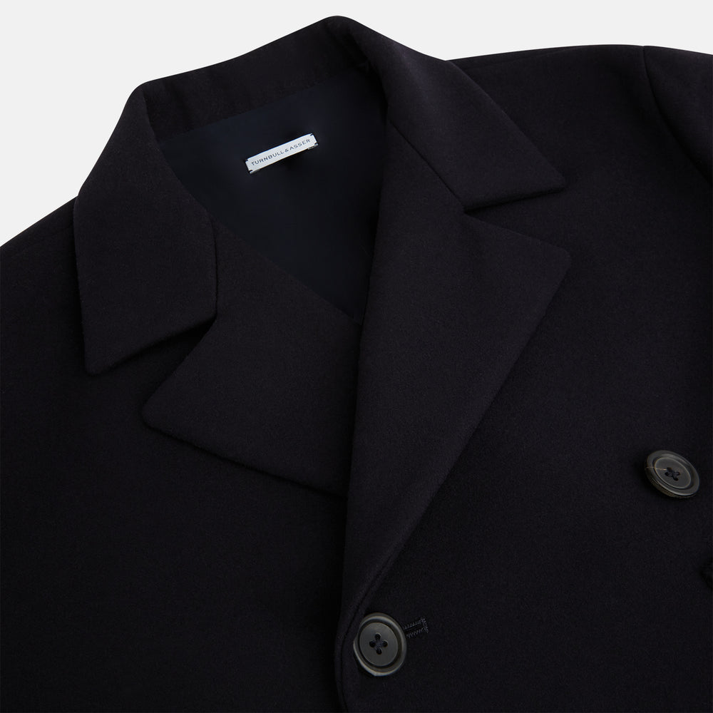 The Turnbull & Asser Navy Wellington Double-Breasted Caban Coat features wide lapels, six front buttons, a chest pocket, and two side pockets with buttoned flaps—ideal for polished formal wear.