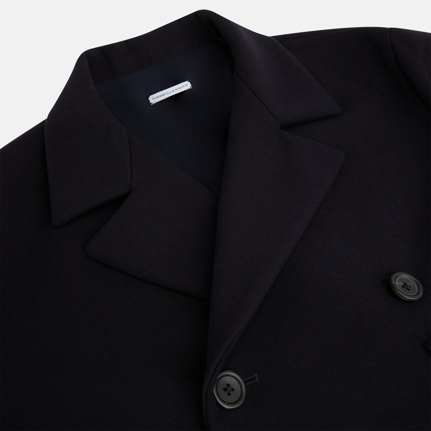 View 2 of product The Turnbull & Asser Navy Wellington Double-Breasted Caban Coat features wide lapels, six front buttons, a chest pocket, and two side pockets with buttoned flaps—ideal for polished formal wear.
