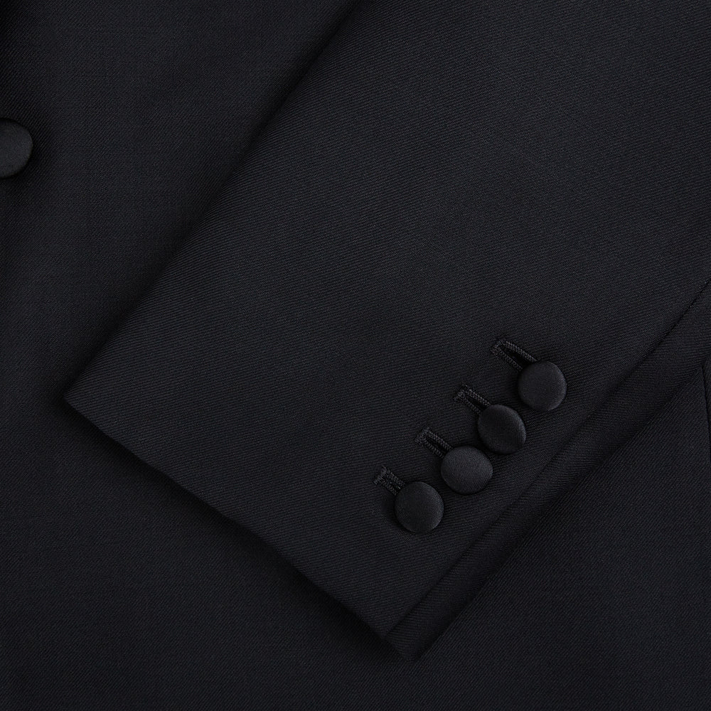 The Turnbull & Asser Black Single Breasted Dinner Suit features fine wool, a satin shawl collar jacket, and matching trousers—perfect formal wear, shown on a plain white background.