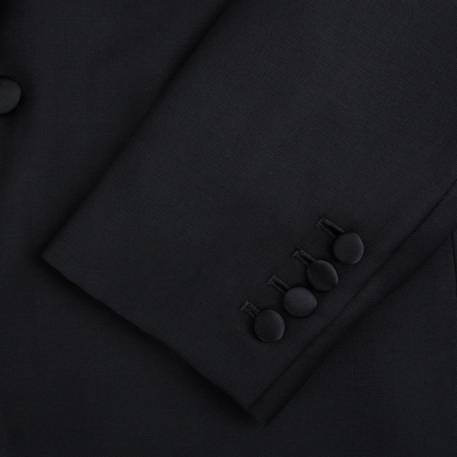 View 7 of product The Turnbull & Asser Black Single Breasted Dinner Suit features fine wool, a satin shawl collar jacket, and matching trousers—perfect formal wear, shown on a plain white background.
