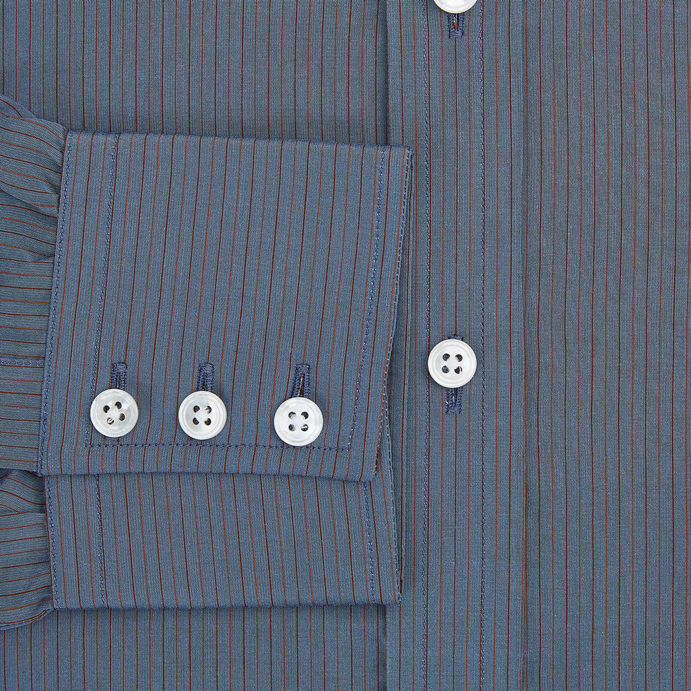 A neatly folded men's Mid Blue Red Stripe Regular Fit Mayfair Shirt by Turnbull & Asser, featuring long sleeves, classic collar, white buttons, and subtle red stripes—a hallmark of the brand’s renowned luxury.