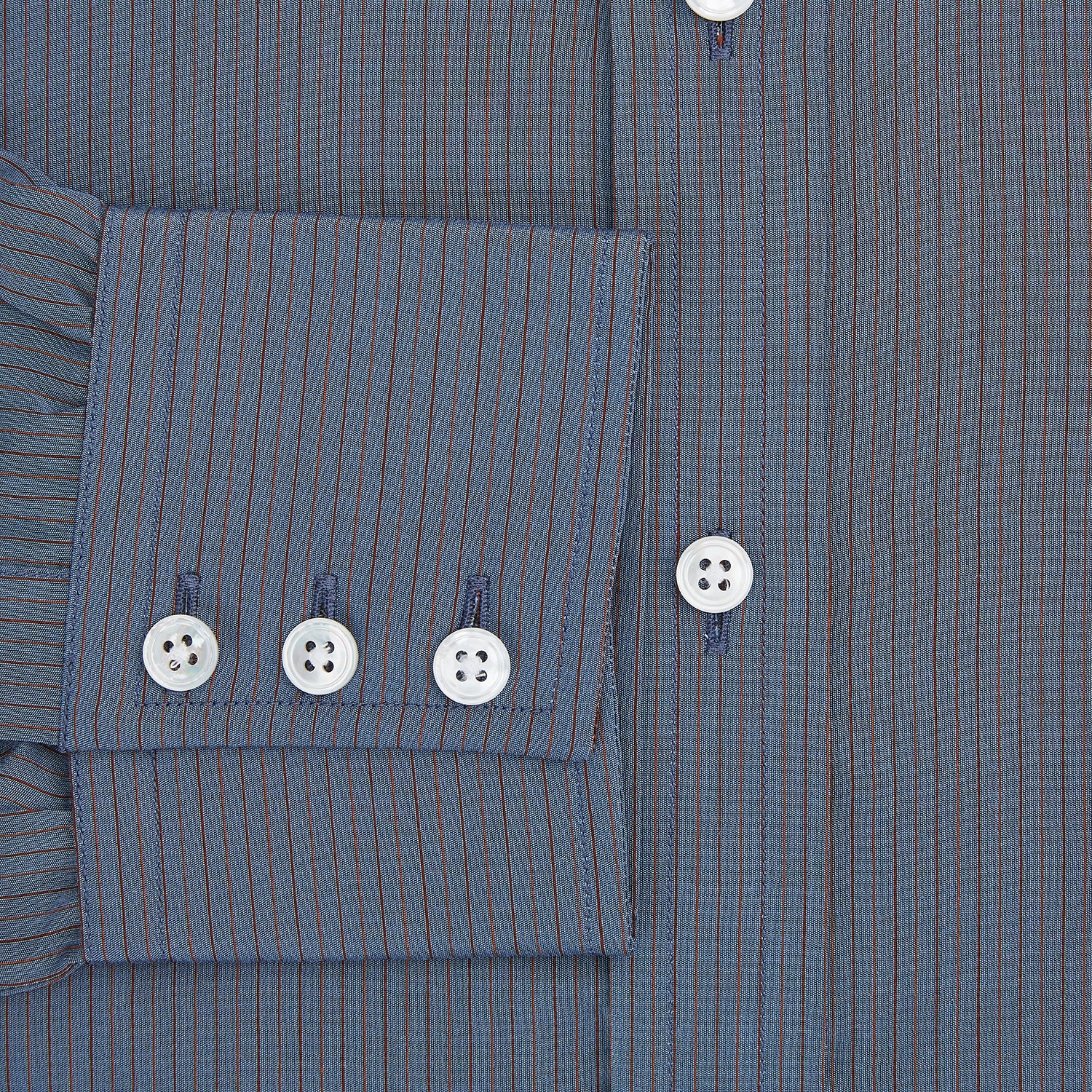 View 5 of product A neatly folded men's Mid Blue Red Stripe Regular Fit Mayfair Shirt by Turnbull & Asser, featuring long sleeves, classic collar, white buttons, and subtle red stripes—a hallmark of the brand’s renowned luxury.