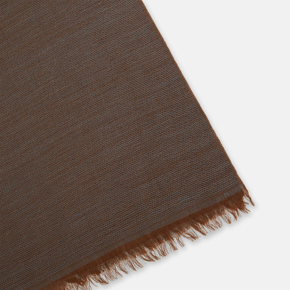 The Turnbull & Asser Brown and Grey Melange Cashmere Scarf features a subtle texture and slightly frayed edges, shown neatly folded with a loose knot on a plain white background.